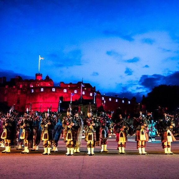Marching band and light show projecting onto the castle