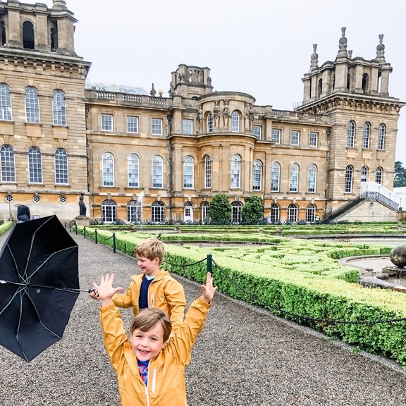 Two boys playing on a path in front of a palace