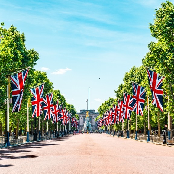 View to Buckingham Palace from the Mall showing union Jack flags