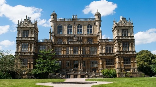 A huge gothic hall on manicured symmetrical gardens