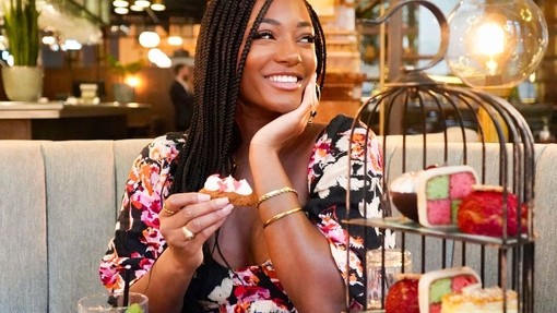 Young woman smiling and sitting at a restaurant table
