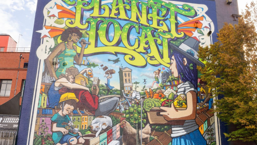 View of colourful street mural on the side of a building