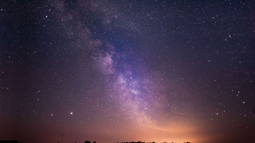 Stars and the Milky Way clearly visible in the night sky.