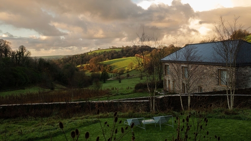 A country homestead amongst rolling hills.
