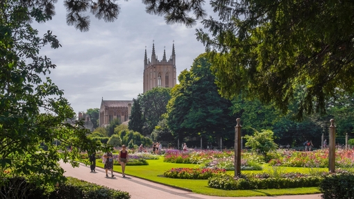 A cathedral amongst manicured gardens on a summer's day