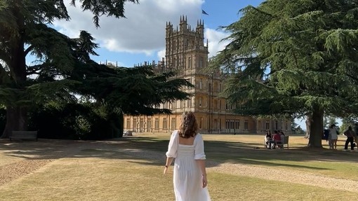 A woman stood outside Highclere Castle, Hampshire