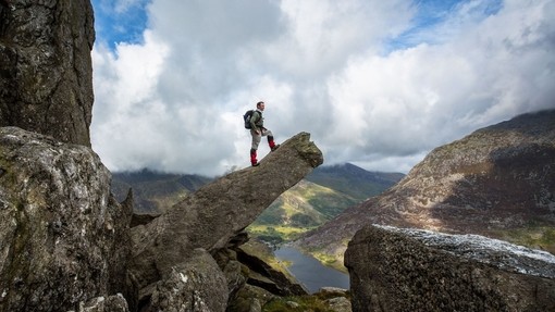 Male hiker admiring view from a pinnacle rock formation