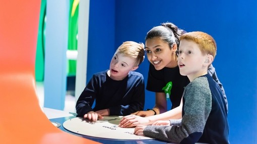 Two boys playing with interactive display in a museum