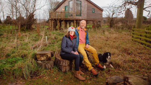 owners sitting in front of cottage