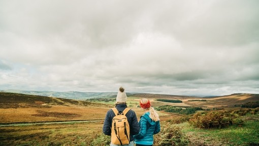 Two girls walking with panoramic views of greenery