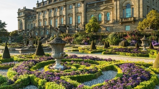 The Victorian formal gardens with statues and low hedges in front of Harewood House