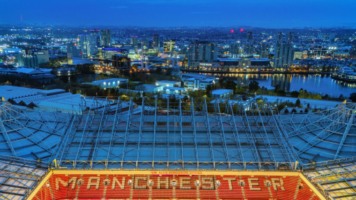 Aerial view of a large football stadium lit up at night.