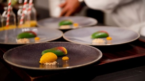 Four dishes of food on a table at a fine dining restaurant