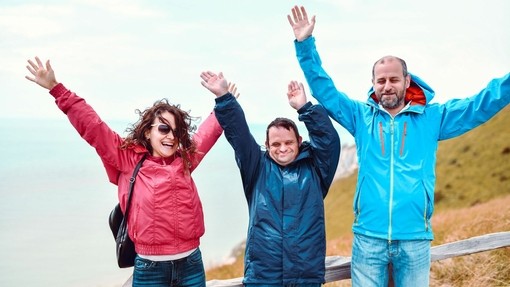 Disabled visitors enjoying spending time together on the coast