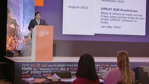 Man makes speech to delegates from podium at event