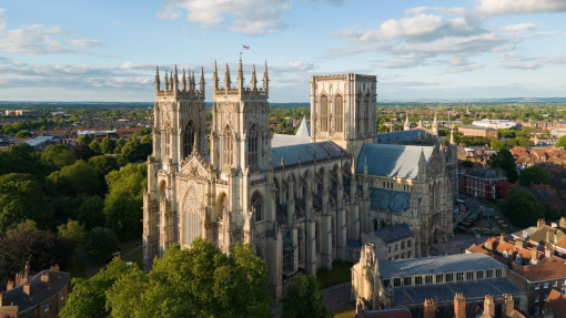 An heritage building rises above a city below