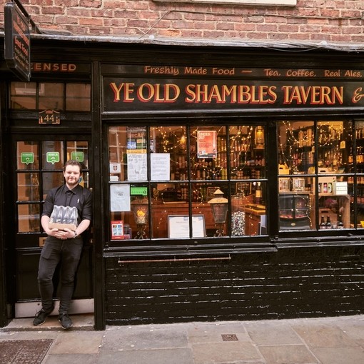 Man standing outside Ye Old Shambles Tavern