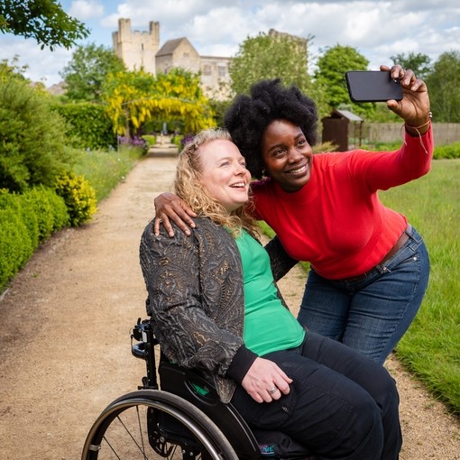 Two women taking a selfie, Helmsley Castle in the background