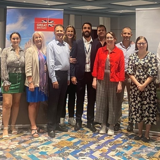Attendees posing for a photo at a Spain Roadshow event in 2022