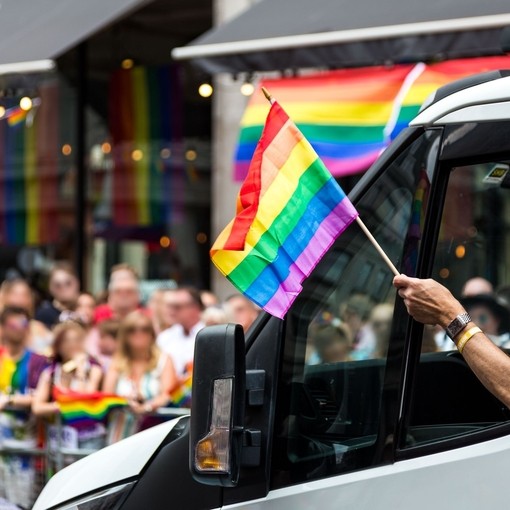 Crowds of people celebrating at the London Pride parade in the city centre.