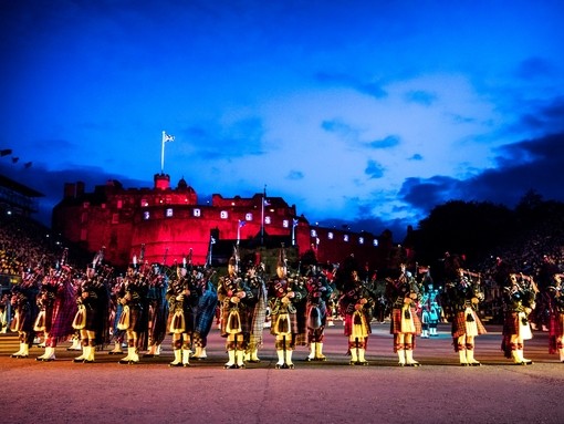 Marching band and light show projecting onto the castle