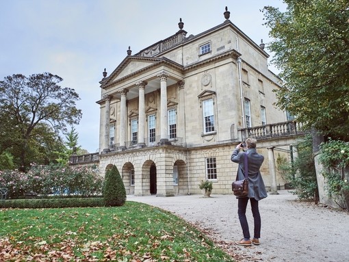 Rear view of man taking picture of The Holburne Museum, Bath, Somerset, England.