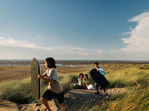 A family enjoy a day out in the sand dunes
