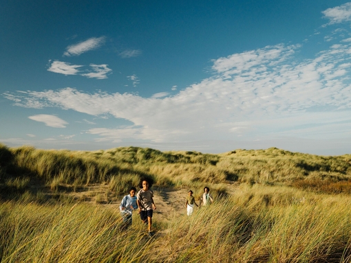 A family enjoy a day out in the sand dunes