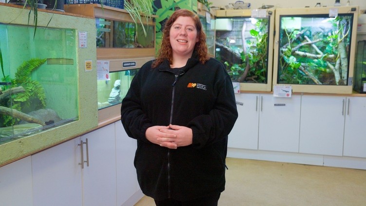 A woman poses in a visitor centre