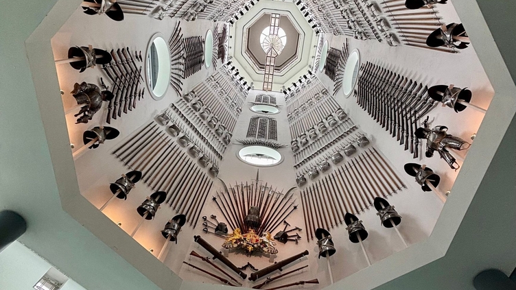The high vaulted and ornate ceiling of an armory museum.