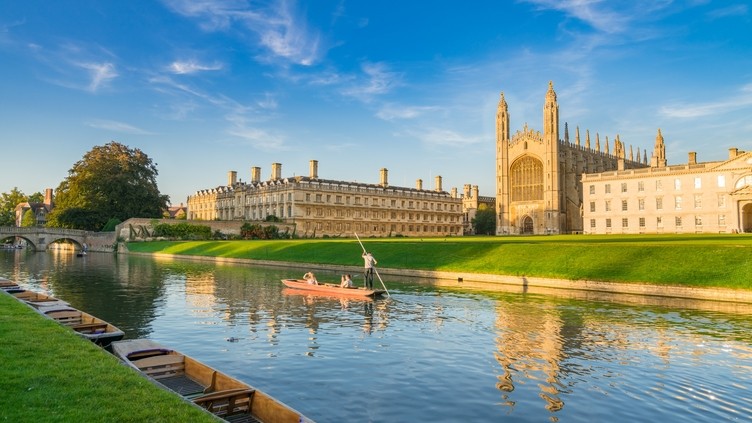 View of college in Cambridge with people punting on River