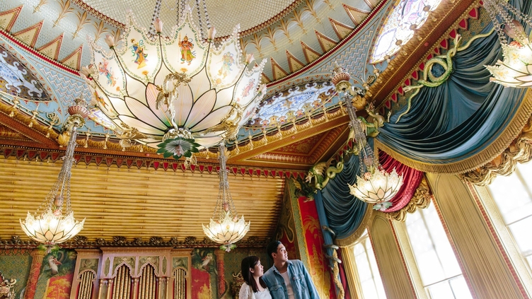 Couple standing in the state banqueting hall of a palace