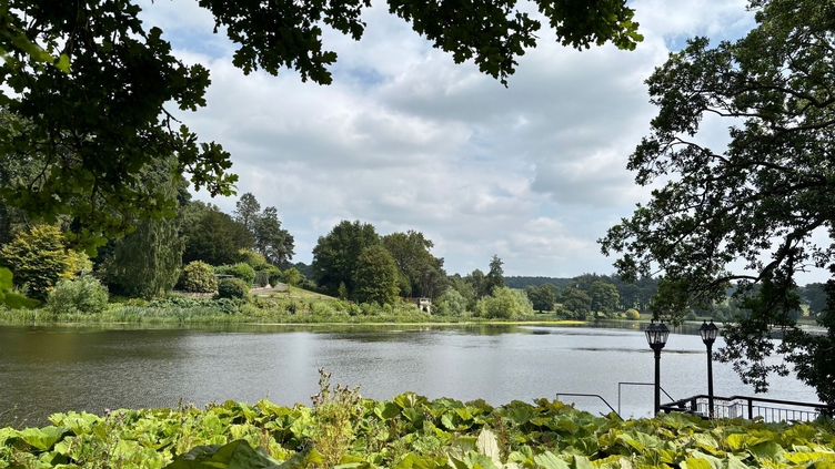 The lake and grounds of a large country house estate.