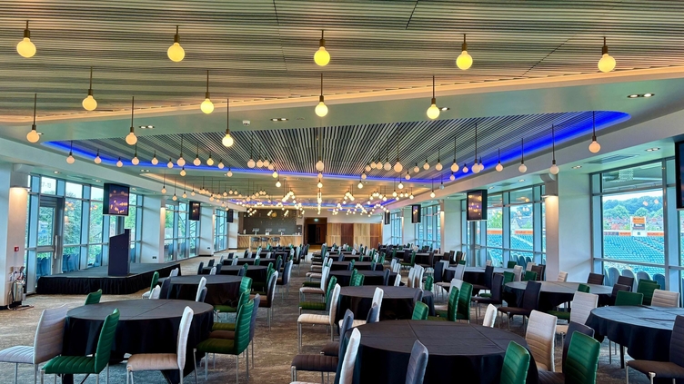 An empty conference space prepared for a gala event inside a sports stadium.