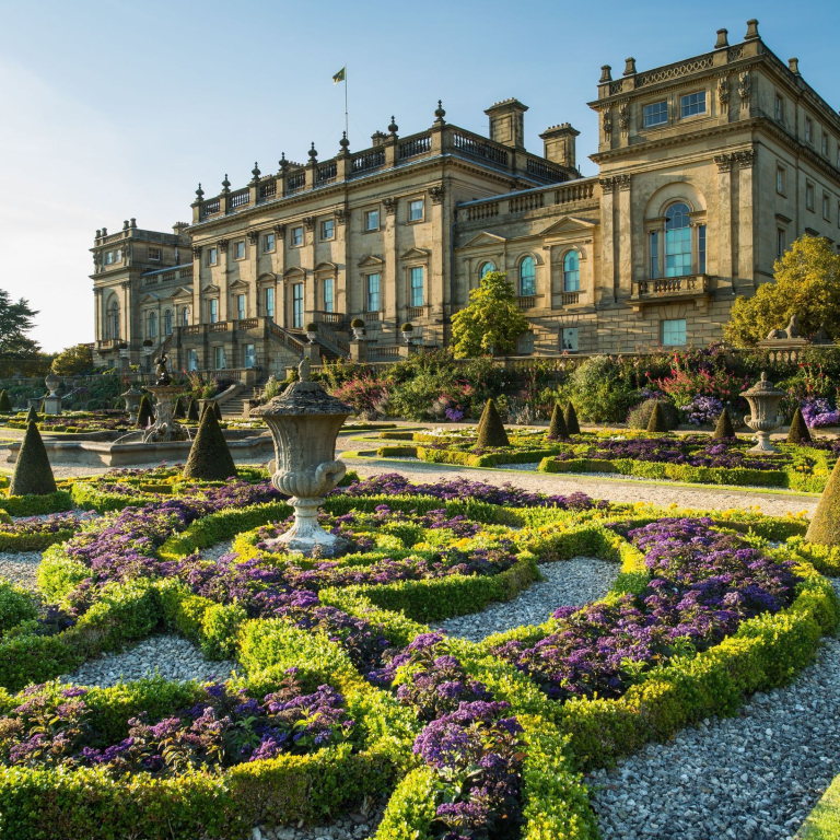 The Victorian formal gardens with statues and low hedges in front of Harewood House