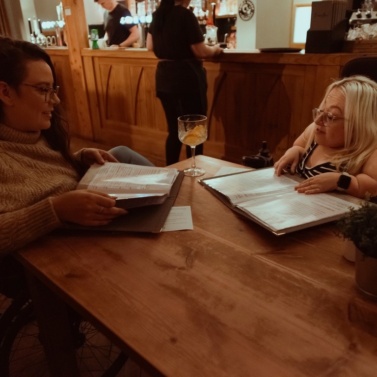 Two women having drinks and a meal at The Inn on the Moor.