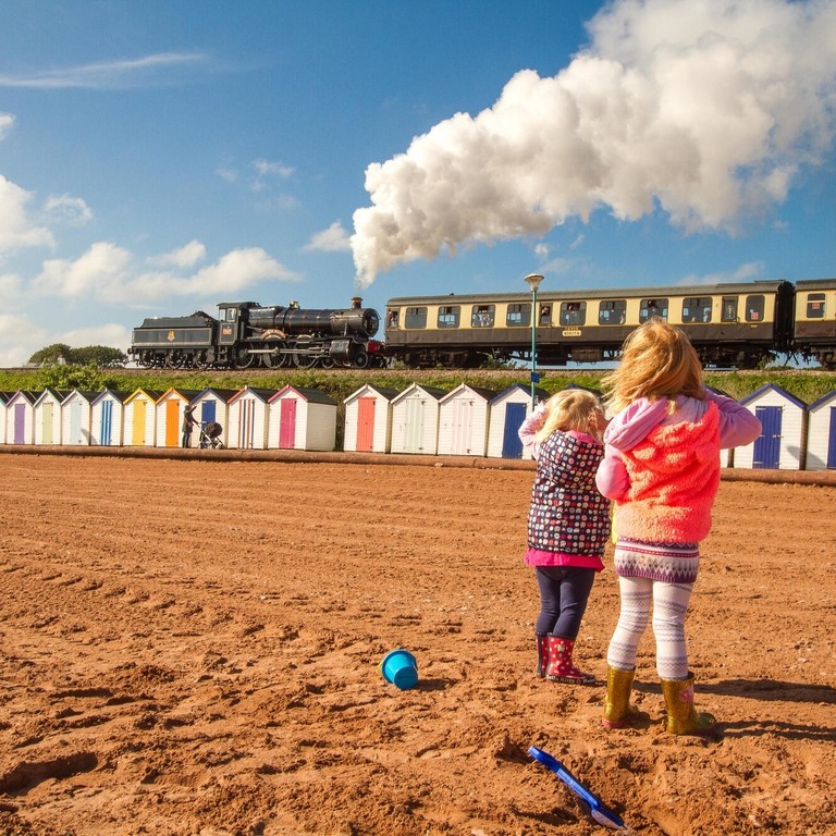 beach huts, steam train railway seaside summer at Paignton 