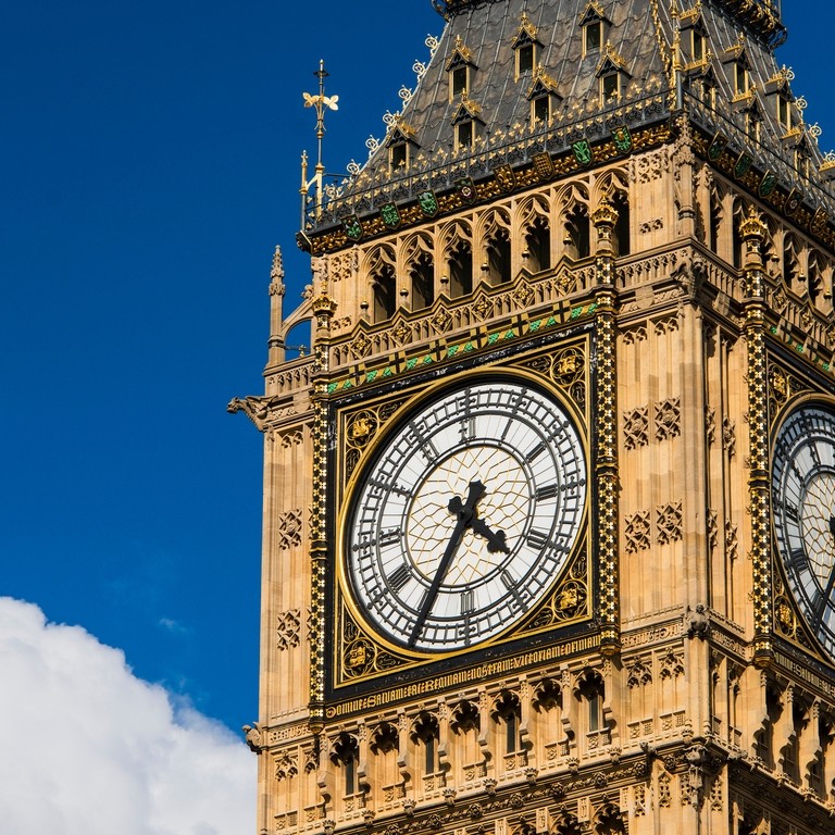 Close up view of the ornate clock face and tower of Big Ben on a bright sunny day. 