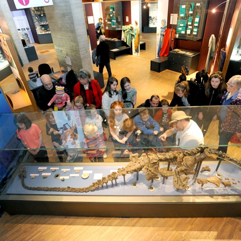 A group of people looking at an exhibit on a tour of The Collection in Lincolnshire