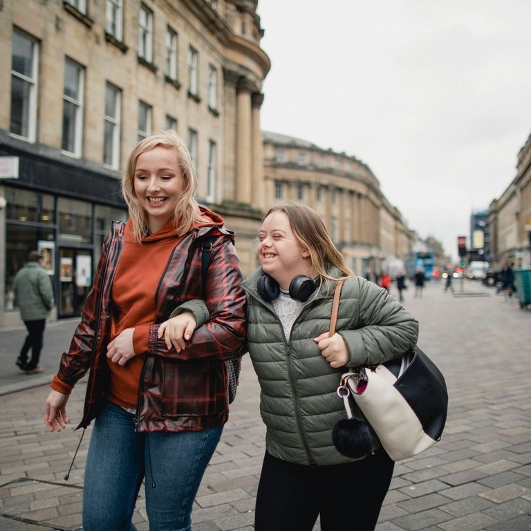 Young female with Downs Syndrome bonding with her friend