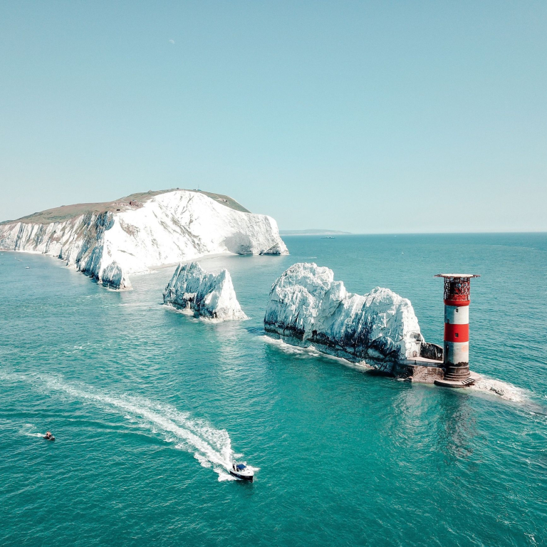 Aerial view of white rock formations standing tall from sea