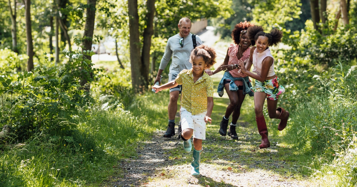 A shot of a diverse family walking in the countryside.