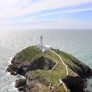 A lighthouse at the end of a peninsula