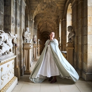 A woman walks through a corridor at a heritage building