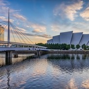 how much do brown tourist signs cost Bell's Bridge and the SEC Armadillo by the river Clyde in Glasgow, at sunrise.