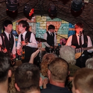 A tribute band playing in an underground nightclub.