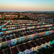 Aerial view of a city and rows of colourfully painted houses