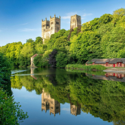 A view of a river with a Cathedral beyond.