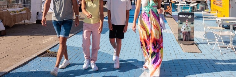 A family visit a Sunday market by the river Tyne in Newcastle upon Tyne