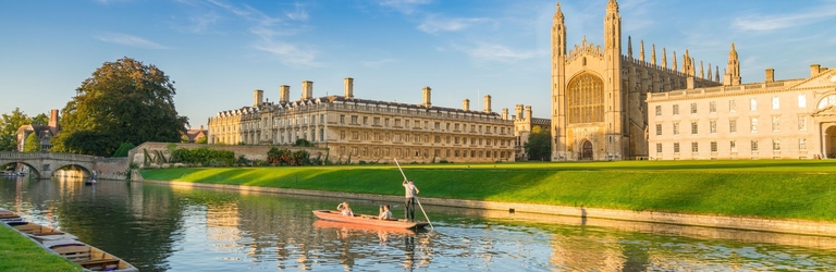 View of college in Cambridge with people punting on River